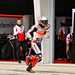 Marc Marquez runs back to the Repsol Honda garage after a crash in qualfying