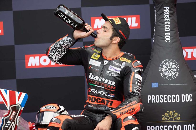 Danilo Petrucci sips champagne after podiuming at Donington Park