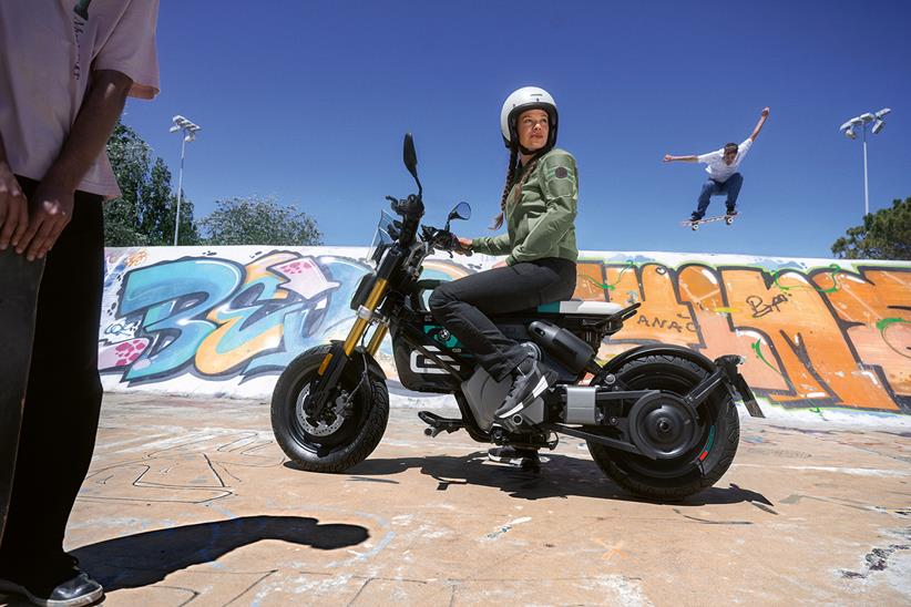 A rider sits on the BMW CE 02