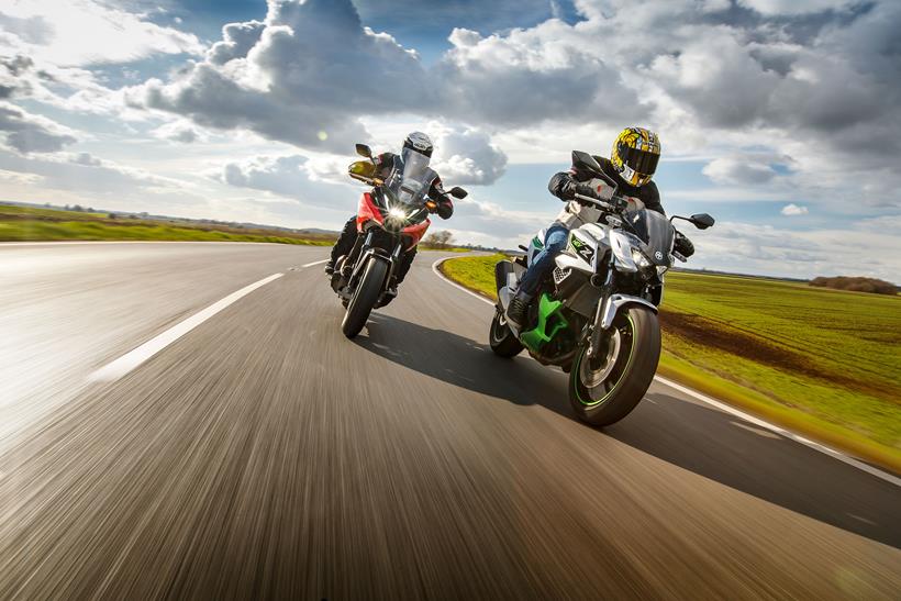 Two motorcyclists riding on the road