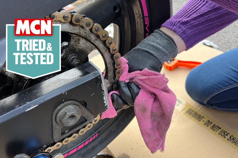 Motorcycle chain being cleaned with a cloth