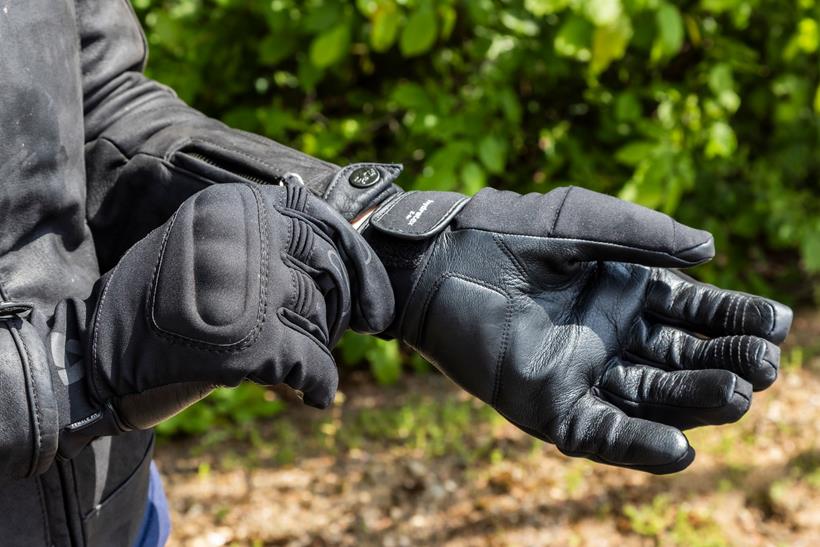 Woman pulling on motorcycle gloves