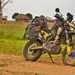 A motorbike in an African village, with lots of luggage on board