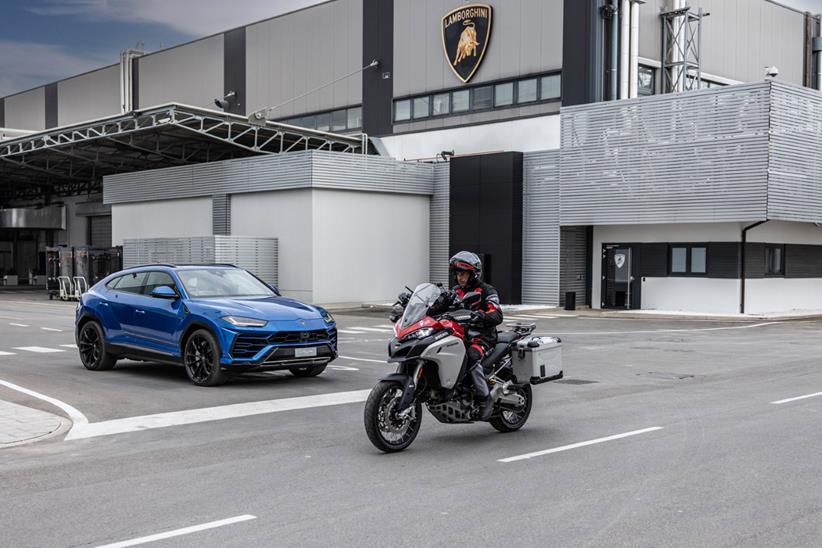 Ducati Multistrada passes Lamborghini Urus at junction