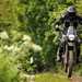 2024-on Royal Enfield Himalayan 450 Joe's Long Term bike jumping on a trail