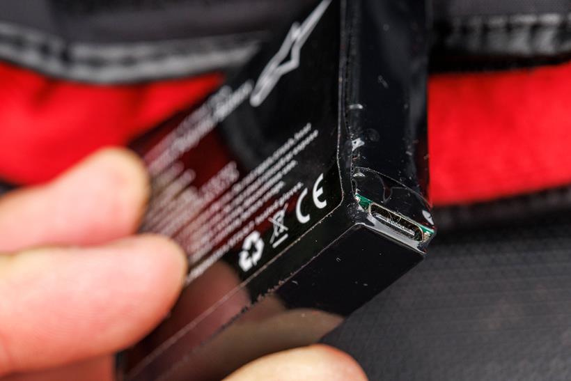 Close up of the Alpinestars HT-7 battery, showing its USB type C charging port