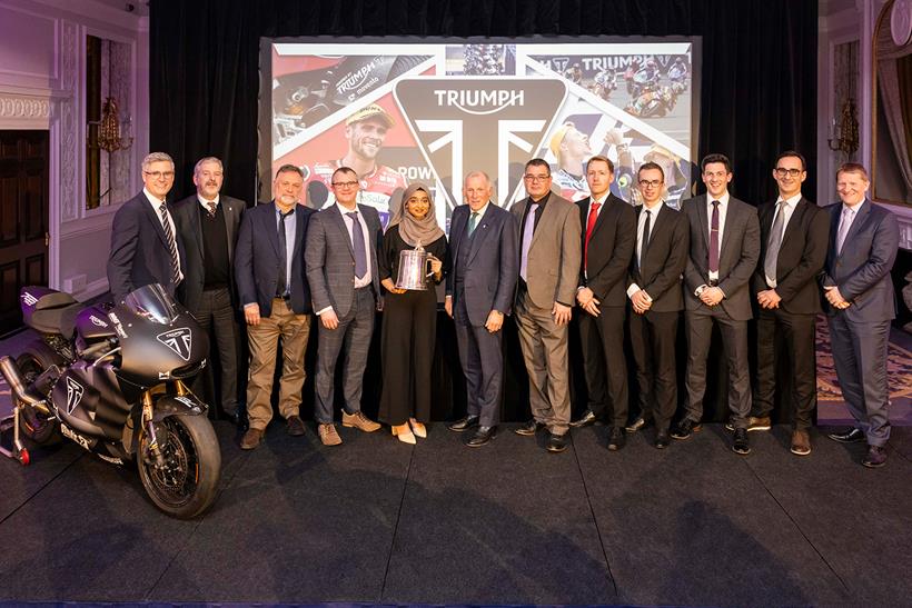 Triumph staff stand for a photo with the Torrens Trophy