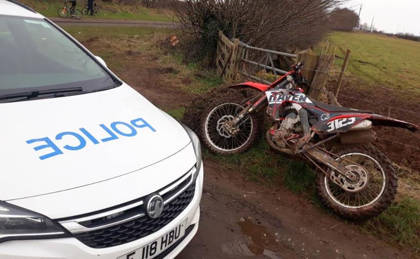 Off-road motorcycle with police car