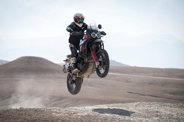 2024 Ducati DesertX Rally jumping a crest off-road