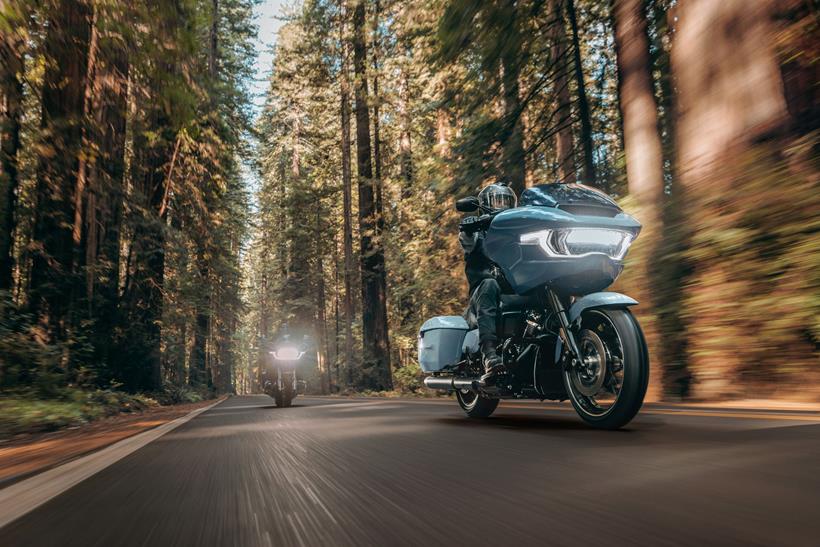 Harley-Davidson baggers riding in a forest