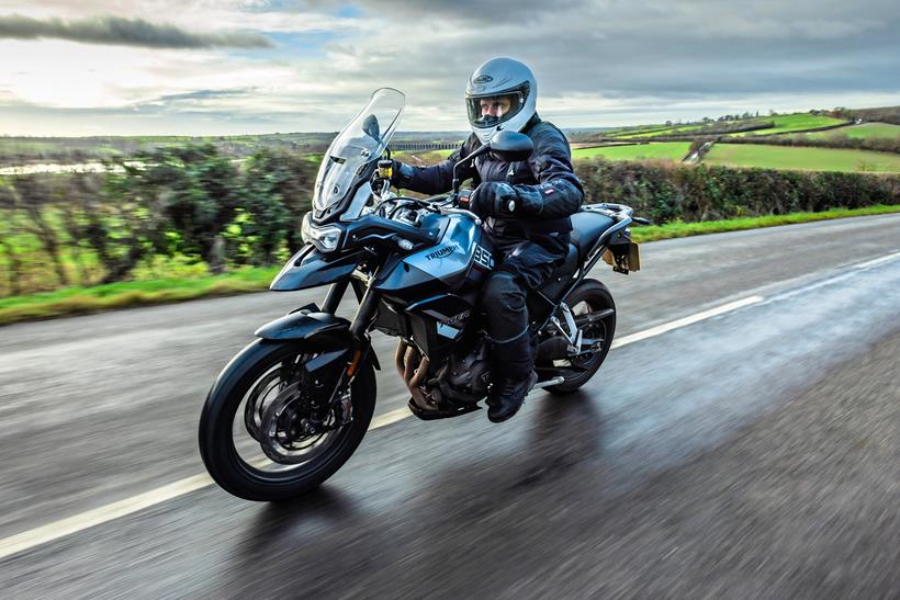 Triumph Tiger 850 Sport in blue and grey ridden on a very straight road