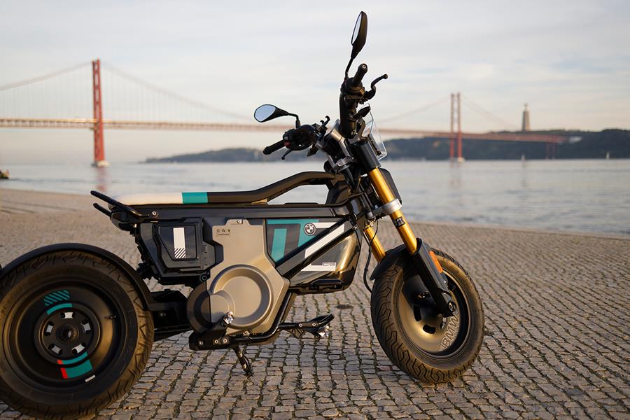 BMW CE 02 parked in front of a river