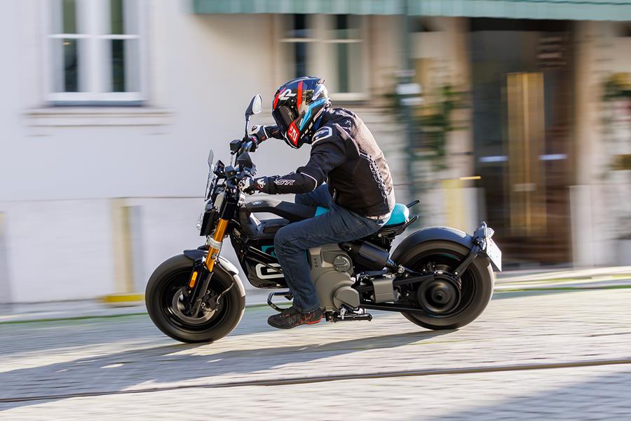 Riding the BMW CE 02 downhill in a turn