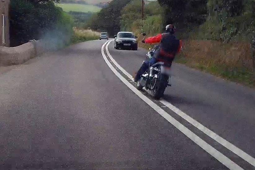 A motorcyclist crosses double white lines in footage submitted to Operation Snap