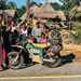 Cake electric motorcycle surrounded by villagers