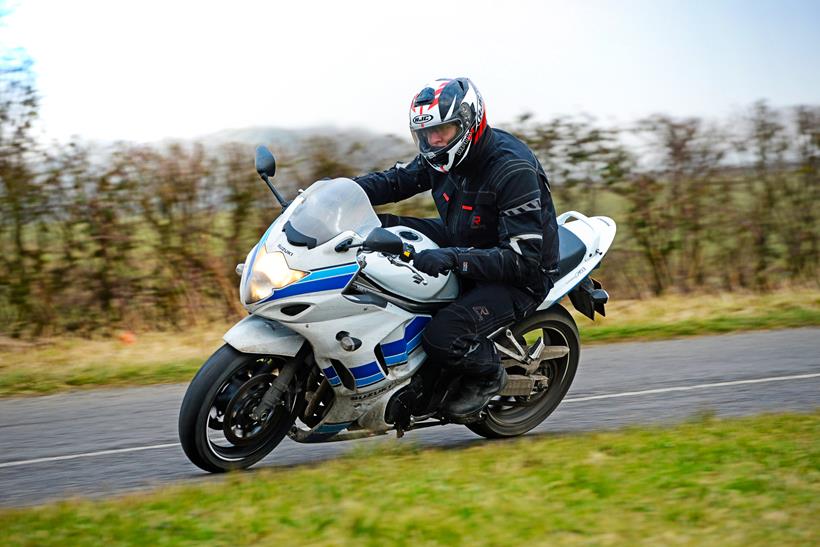 Suzuki GSX1250FA riding shot on the road cornering quickly with Jon Urry on board