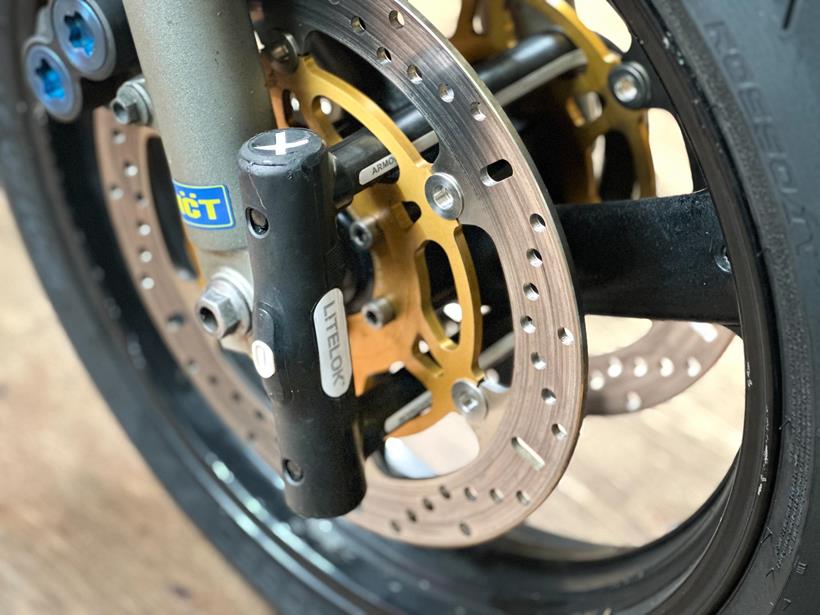 The Litelok X1 Moto positioned through the front wheel and brake disc