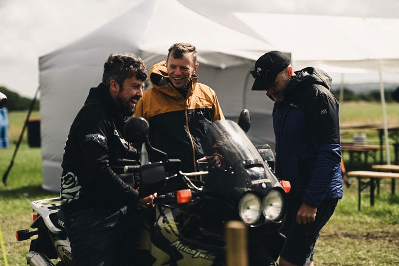 Three guys having a chat over an old Africa Twin