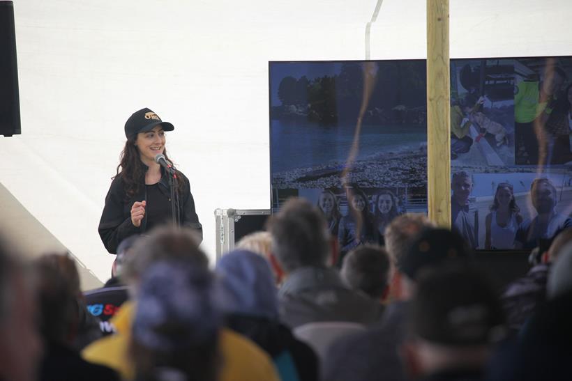 Jaderides speaking about her trip on stage