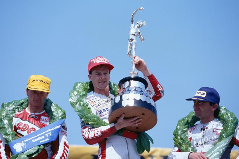 Steve Hislop holding up Senior TT trophy