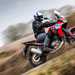2024 Honda Africa Twin side profile riding through the countryside
