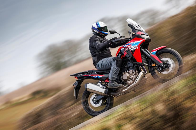 2024 Honda Africa Twin side profile riding through the countryside