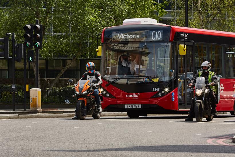 Motorcyclist at junction followed by bus