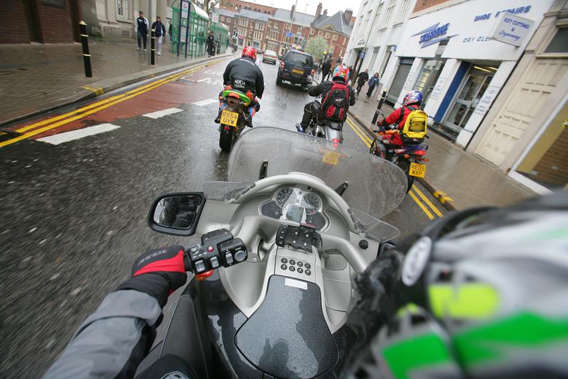 Motorcyclists riding alongside empty bus lane