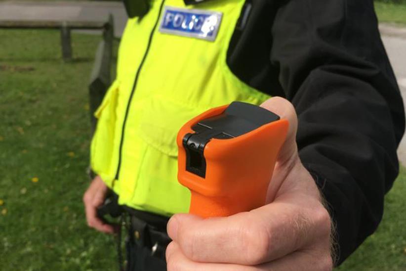 Police officer holding DNA spray canister