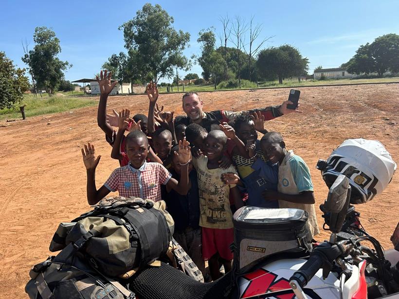 Derek among a group of local children