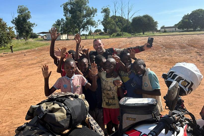 Derek among a group of local children