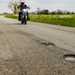 Motorcyclist appraoches potholes