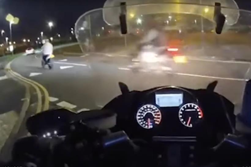 Illegal riders pass police bike at junction