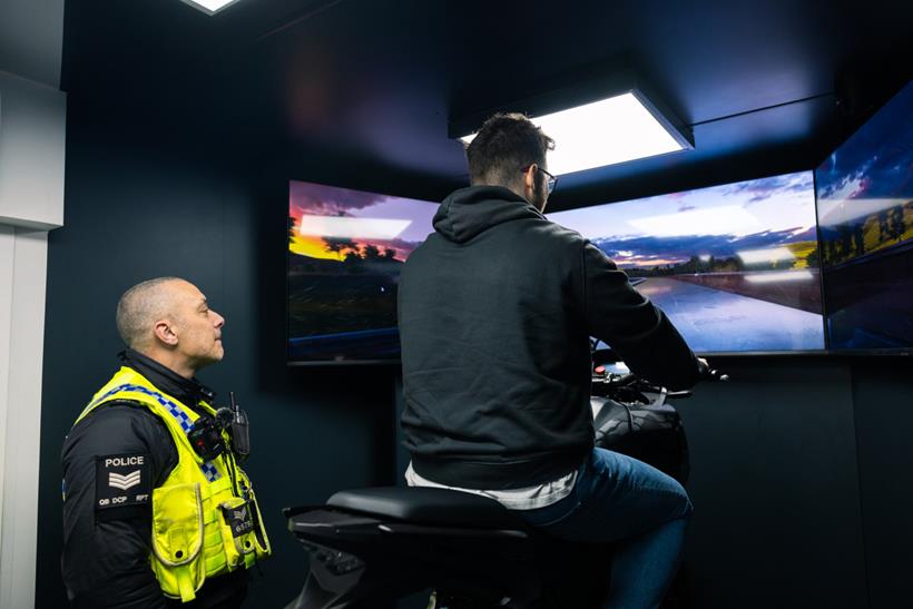 Police watch rider try the simulator