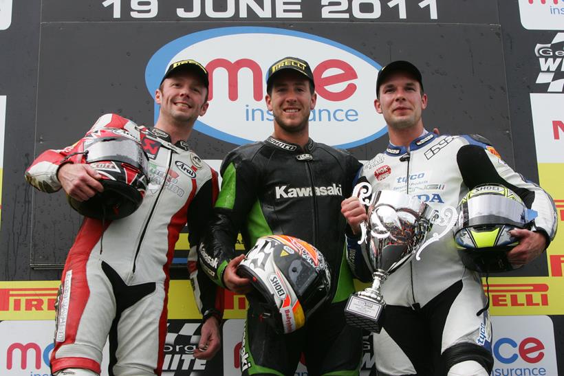 Simon Andrews stands on a 2011 British Superbike podium