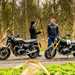 Both Saffron Wilson and Jon Urry stood next to the parked BMW R12 nineT and Triumph Twin 1200 in a discussion