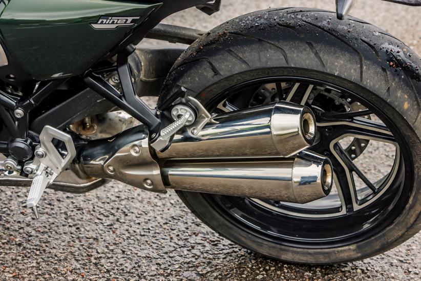 BMW R12 nineT rear left hand picture showing the twin pipe fanned exhaust and open wheel mounted to the single sided swing arm