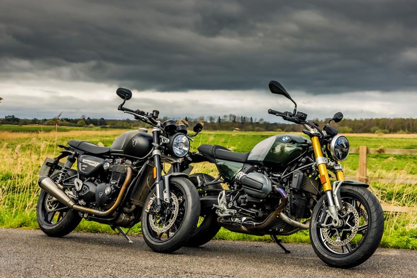 BMW R12 nineT Vs Triumph Twin 1200 both bikes parked closely facing the same direction pointing forward in a staggered line