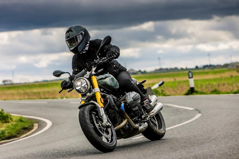 BMW R12 nineT riding through a right hand bend with bike and rider leaning into the corner