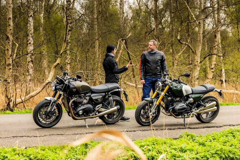 Both Saffron Wilson and Jon Urry stood next to the parked BMW R12 nineT and Triumph Twin 1200 in a discussion