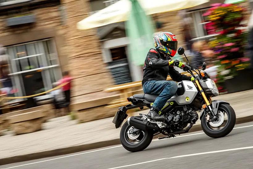 Rider in built up area on Honda Grom