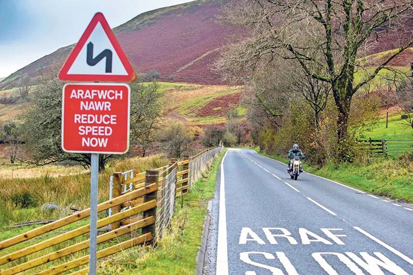 Motorcyclist in Wales approaching 'slow' sign