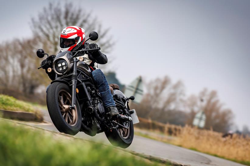 Honda CMX500 Rebel leaning into a right hand turn with grass in foreground