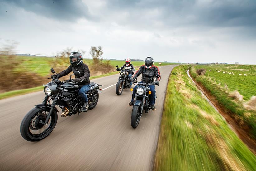 Group shot of the Kawasaki Eliminator, Honda Rebel, and Royal Enfield Shotgun riding down the road chasing the camera again