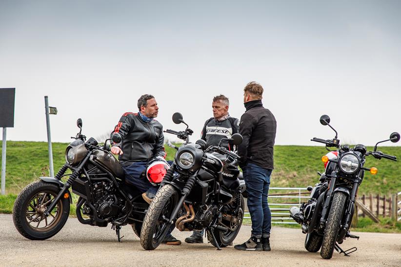 Group shot of Mild Cruisers test, with bikes stationary surrounded by riders in discussion