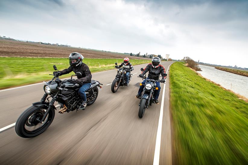 Group shot of the Kawasaki Eliminator, Honda Rebel, and Royal Enfield Shotgun riding down the road chasing the camera