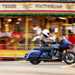 Indian Challenger Dark Horse vs Harley-Davidson Road Glide - side shot of Indian riding past in front of carousel 2