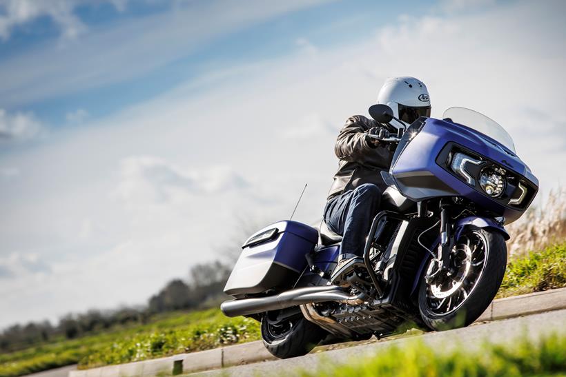 Indian Challenger Dark Horse vs Harley-Davidson Road Glide - Indian riding past on a left hand corner