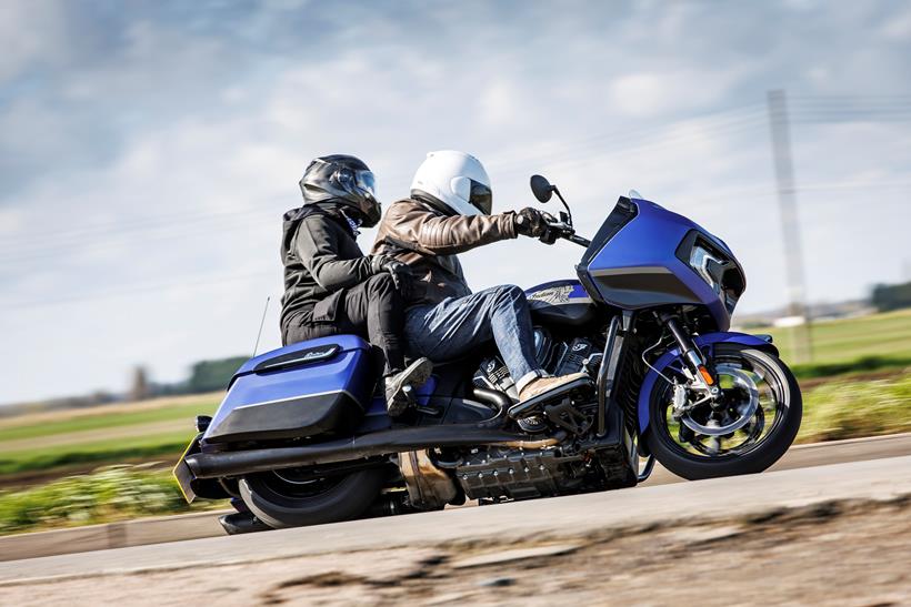 2024 Indian Challenger Dark Horse vs Harley-Davidson Road Glide - Indian riding past with pillion