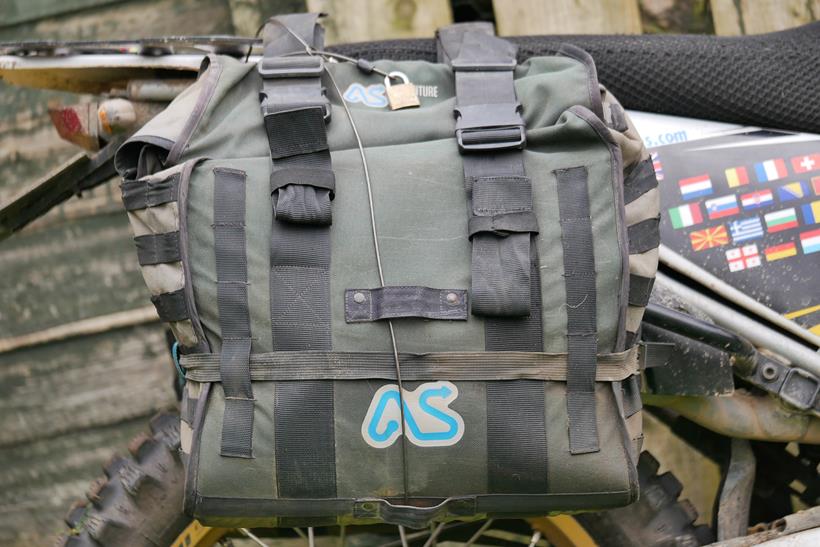 The Adventure Spec Magadan MK3 panniers, showcasing the security loops with a security cable passed through